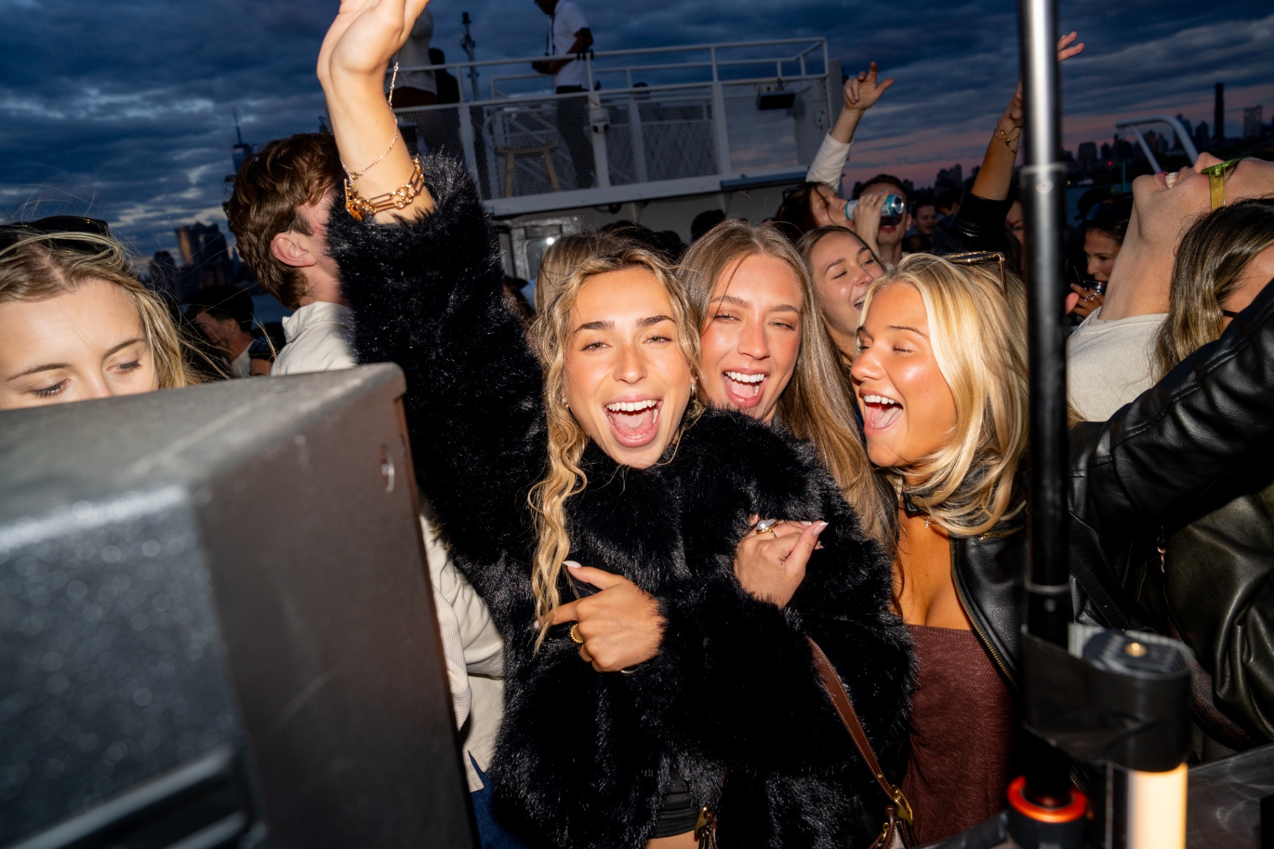 Girls cheering at sunset on the deck