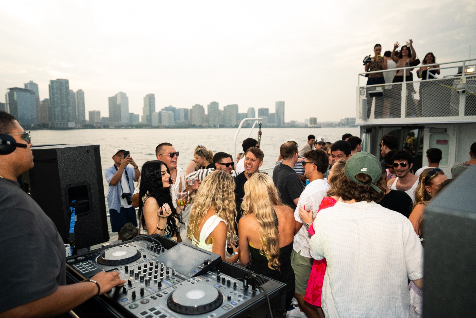 People dancing on the deck at sunset