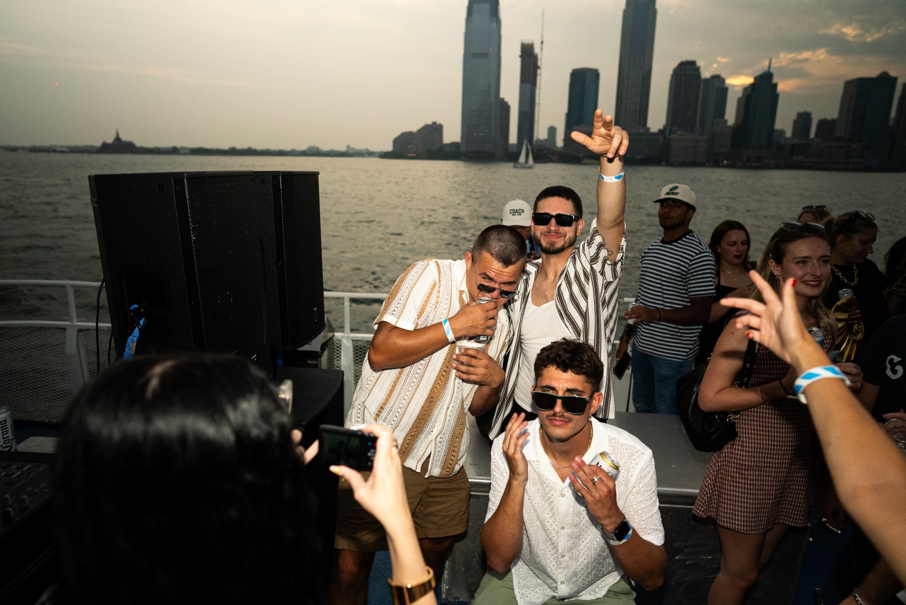 Group posing with Jersey City skyline at golden hour