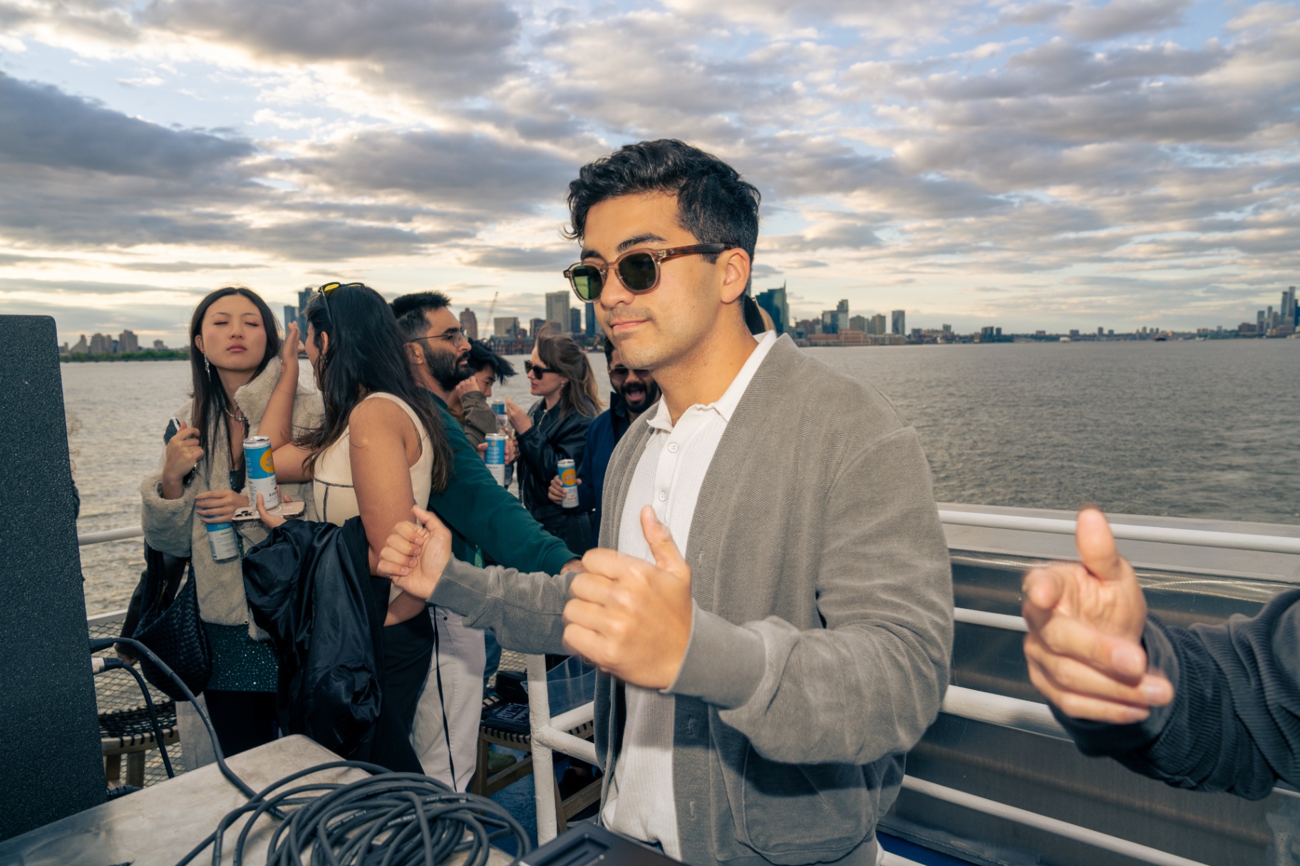 Guy dancing with Hudson River skyline behind
