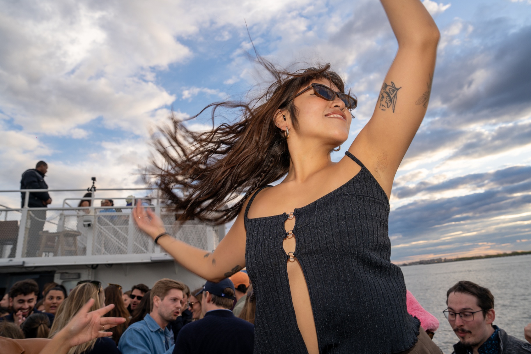 Party crowd on deck with skyline behind